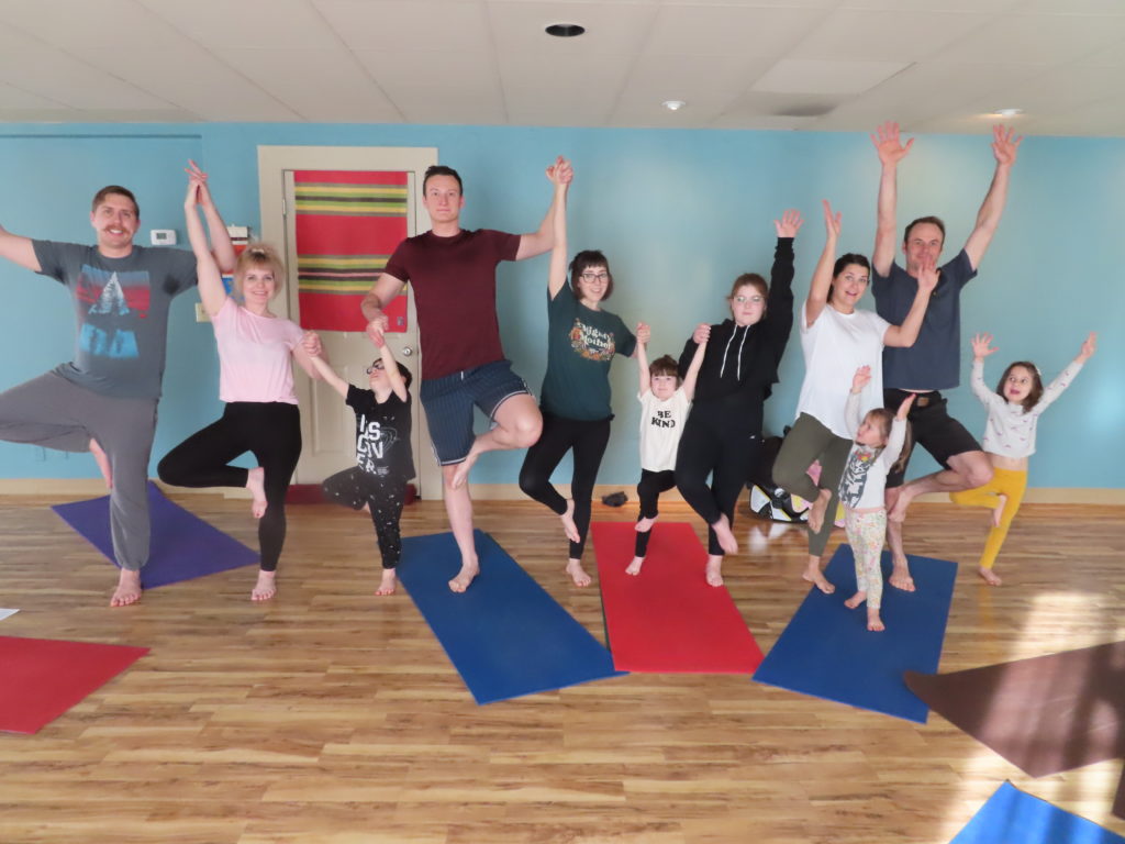 Family Yoga - picture of parents and kids making a forest of trees